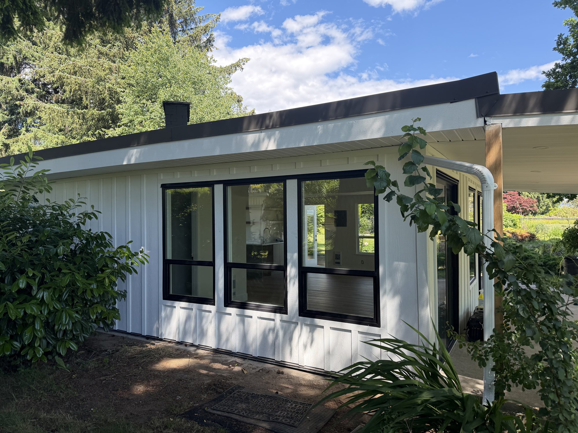 Remodelled cottage exterior with black framed glazing