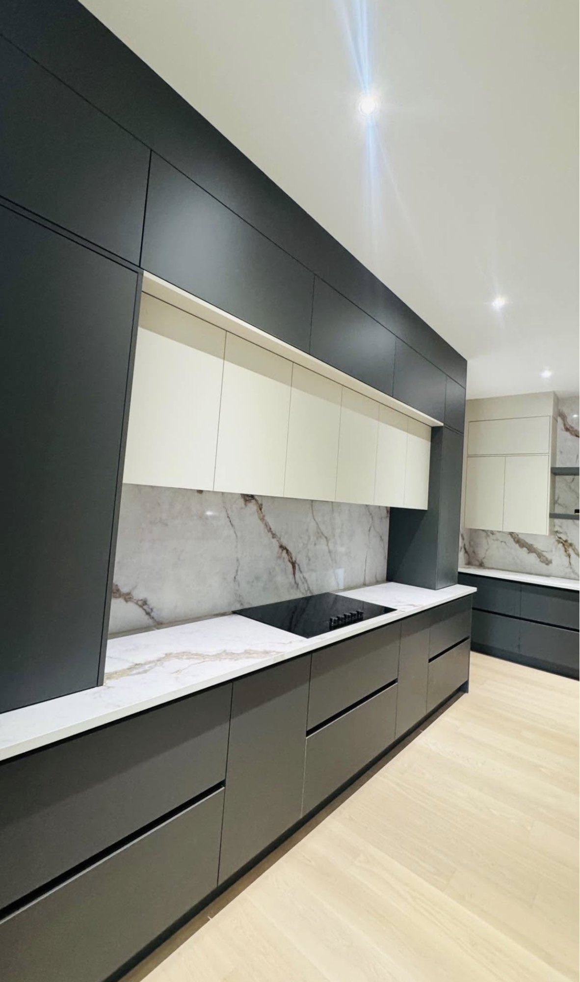 Custom kitchen cabinetry with stone counters and backsplash